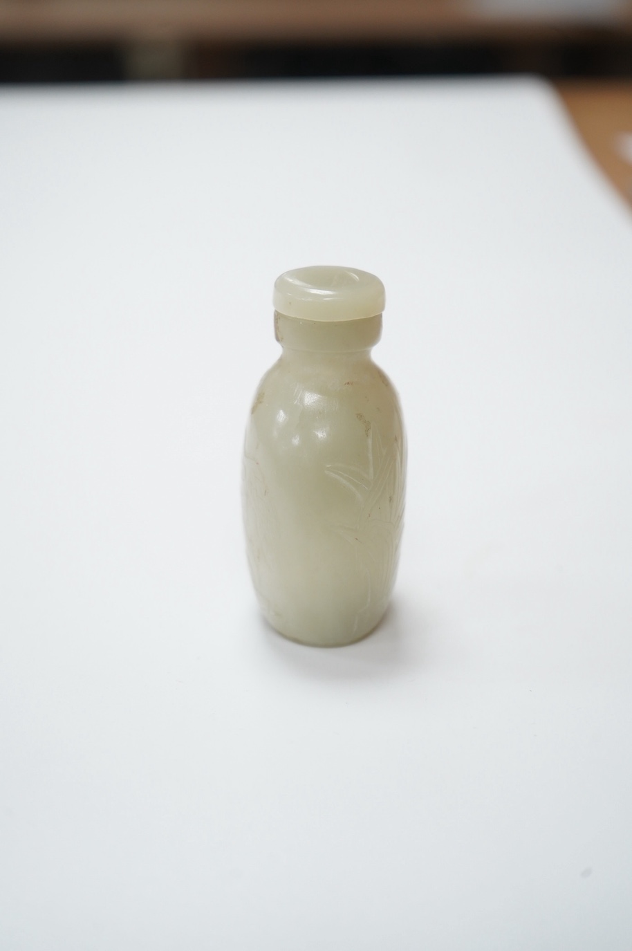 A Chinese carved jade snuff bottle with stopper, 7cm high including stopper. Condition - good